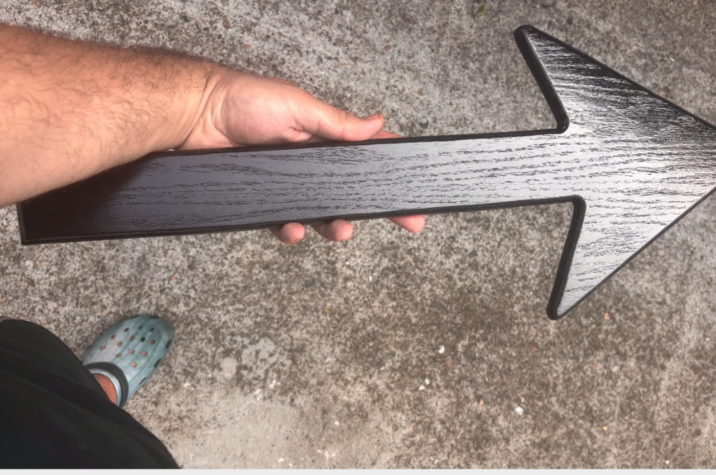 Hand-made gloss black arrow prop held on set