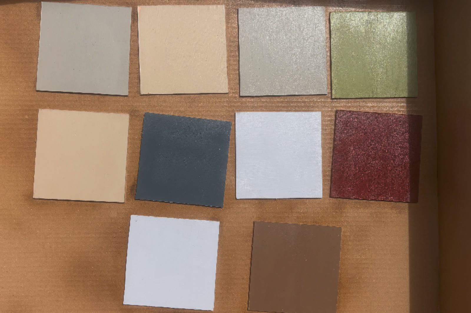 Set paint swatches drying on cardboard in the sun